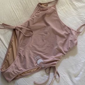 One piece suit ties and cinches at sides.